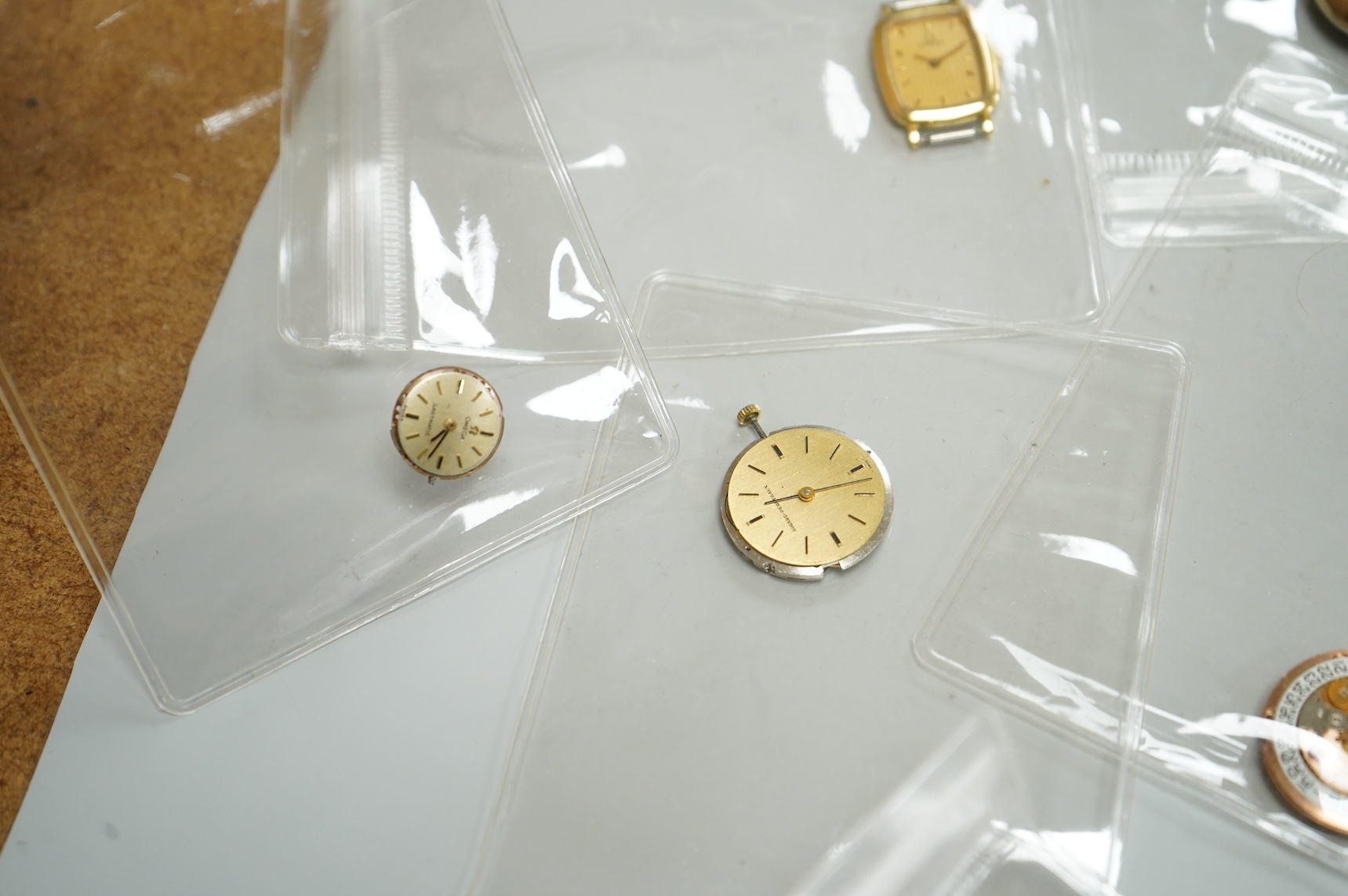 A small collection of assorted lady's and gentleman's wrist watches, including three Omega De Ville steel and gold plated quartz watches and wrist watches movements including Girard Perregaux.